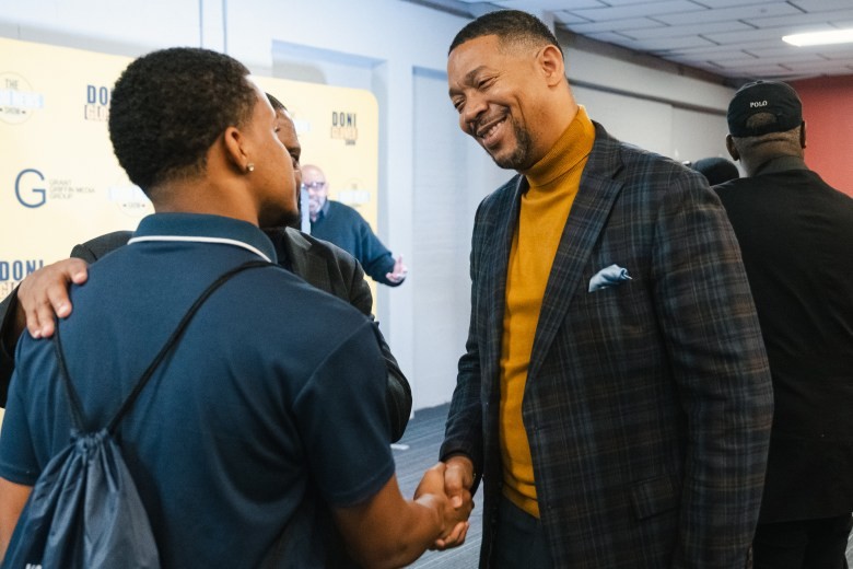 Community leader greeting youth