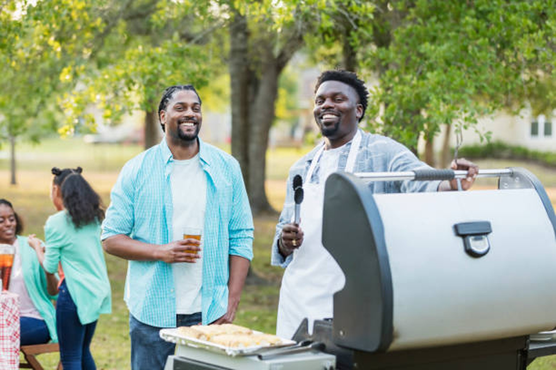 Man grilling at backyard gathering